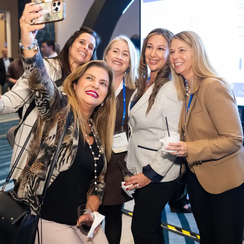 A group of attendees takes a photo together